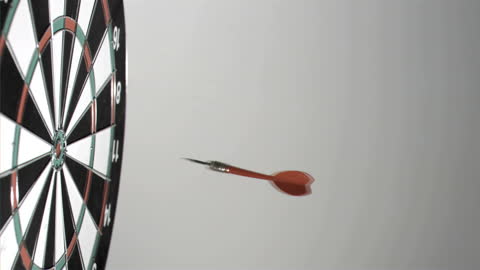 Precision Dart Hitting Bullseye on Dartboard
