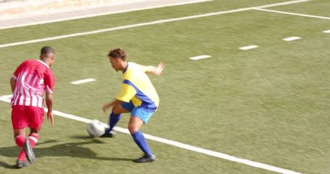 School Soccer Players Discussing Strategy on Field During Match