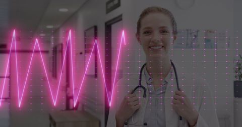 Smiling Female Doctor in Hospital with Cardiograph Overlay - Download Free Stock Images Pikwizard.com