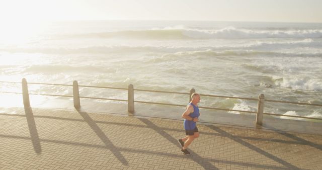 Man Jogging Along Seaside Promenade at Sunrise - Download Free Stock Images Pikwizard.com