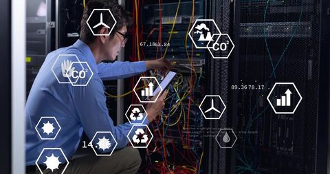 Engineer analyzing computer servers with eco icons overlay