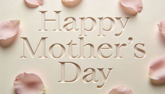 Celebrating mother's day with embossed letterpress greeting and pale pink rose petals