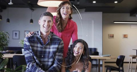 Startup team collaborating over tablet with futuristic circular hud overlay in coworking