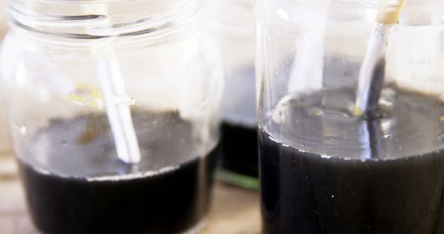 Closeup of Pipettes in Dark Liquid in Glass Jars for Scientific Experiment - Download Free Stock Images Pikwizard.com