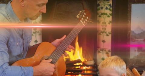 Father Teaching Son Guitar Near Cozy Home Fireplace