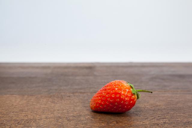 Close-up of strawberry on wooden table