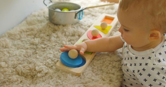 Baby playing with wooden shape sorter on soft carpet - Download Free Stock Images Pikwizard.com