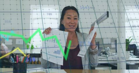 Businesswoman Analyzing Financial Graphs in Office Environment