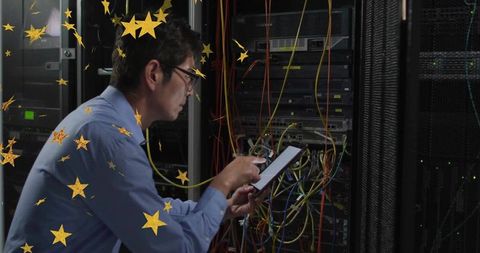 Technician Analyzing Data Center with Tablet and Cables