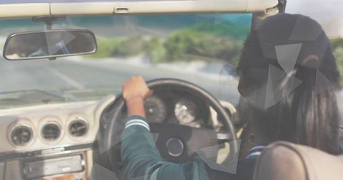 Female driver driving convertible on scenic highway hands on wheel with dashboard view