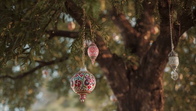 Artistic metal ornament with ethnic design hanging on tree
