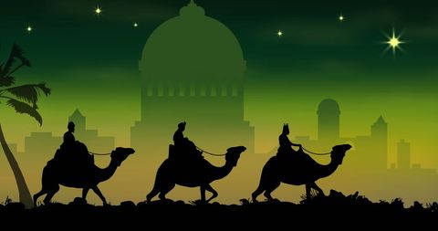 Silhouette of three wise men on camels against night sky
