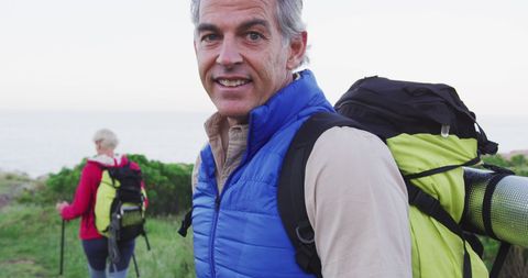 Senior Hiker Adventuring Outdoors with Backpack on Grassy Field - Download Free Stock Images Pikwizard.com