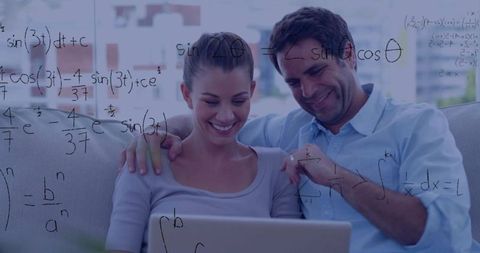 Couple solving math together on laptop in bright living room, home learning collaboration