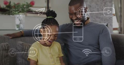 Father and daughter sharing digital connection on couch, enjoying online family bonding