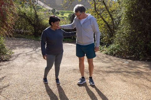 Senior Couple Strolling in Sunlit Park