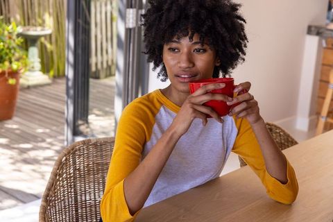 Woman Relaxing with Coffee Mug in Warm, Natural Interior Setting