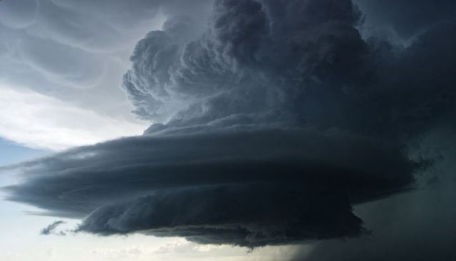 Rotating Layered Supercell Thunderstorm Over Open Plain With Dramatic Shelf Cloud