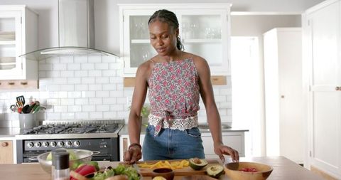 African American Woman Preparing Food in Modern Kitchen