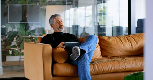 Relaxed Middle-aged Man Using Tablet in Office Lounge - Download Free Stock Images Pikwizard.com