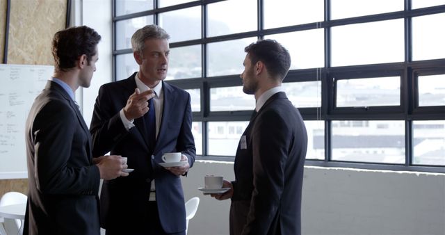 Business Colleagues Discussing Strategy During Coffee Break in Modern Office - Download Free Stock Images Pikwizard.com