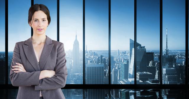 Businesswoman confidently standing with arms crossed, overlooking city skyline through large windows. Suitable for corporate websites, business presentations, executive training programs, leadership workshops, and articles on professional success.