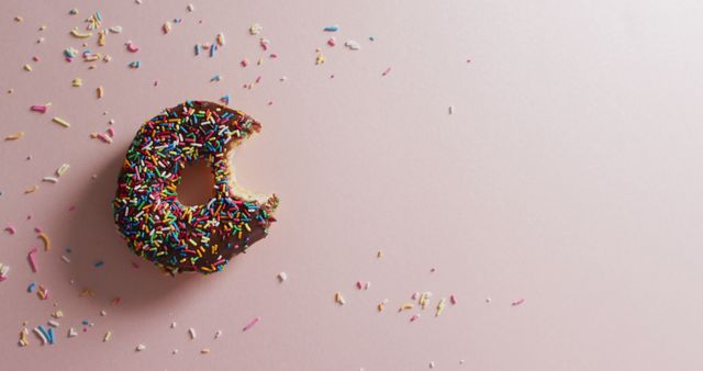 Partially Eaten Donut with Colorful Sprinkles on Pink Background - Download Free Stock Images Pikwizard.com