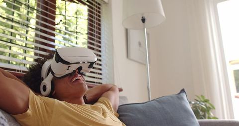 Relaxed man enjoying virtual reality at home