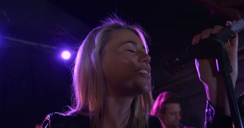Female Singer Rehearsing with Band Under Purple Stage Lights - Download Free Stock Images Pikwizard.com