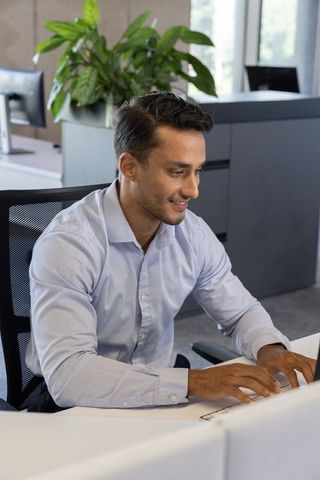 Office Professional Typing at Modern Workspace