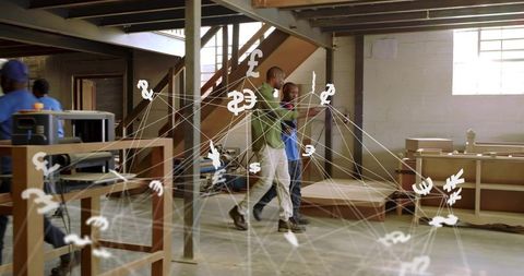 Mentoring carpenters walking through workshop showing digital currency network overlay