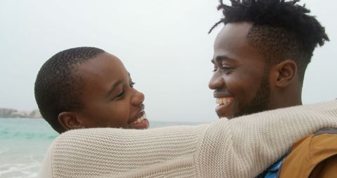 Joyful African American Couple Embracing on Beachside - Download Free Stock Images Pikwizard.com