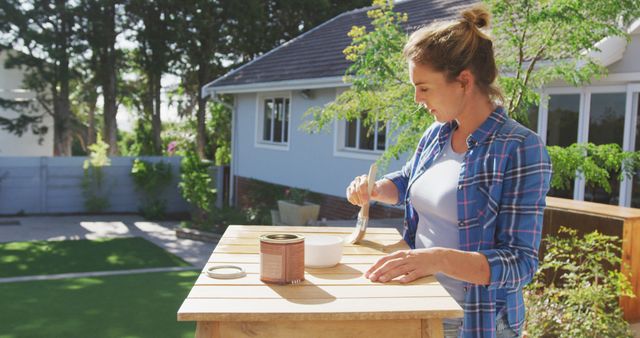 Woman Painting Wooden Furniture Outdoors on a Sunny Day - Download Free Stock Images Pikwizard.com