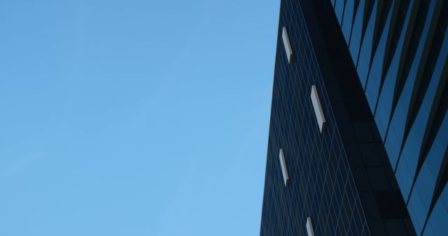 Close up of black modern building in city with blue sky - Download Free Stock Photos Pikwizard.com
