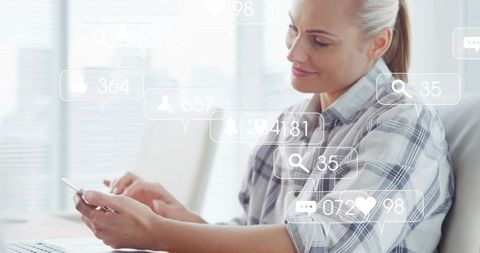 Tapping Smartphone While Viewing Social Media Notifications at Bright Office Desk