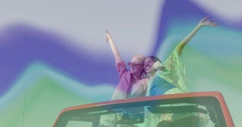 Joyful Friends Taking Selfie in Convertible with Colorful Sky