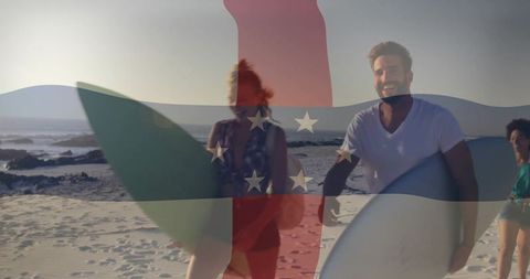 Friends enjoying surfing adventure walking on sunny beach