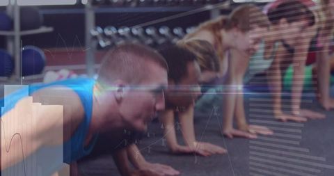 Group fitness plank class showing core strength team training dynamic workout energy