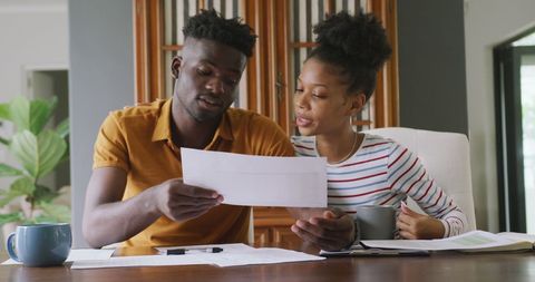 Focused Couple Planning Finances Together at Home