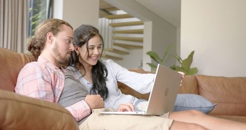 Young Diverse Couple Relaxing with Laptop in Living Room - Download Free Stock Images Pikwizard.com