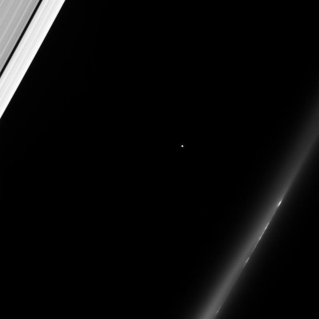 The Cassini spacecraft gazes toward a distant star as Saturn rings slip past in the foreground. At upper left is the outer A ring, with its dark Keeler Gap. At lower right, a train of bright clumps shuttles past in the wispy F ring