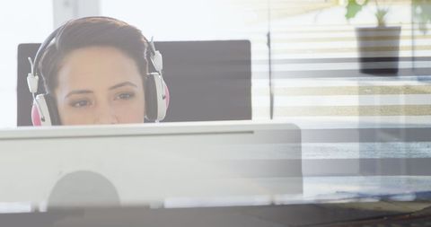 Businesswoman Working with Headphones in Modern Office
