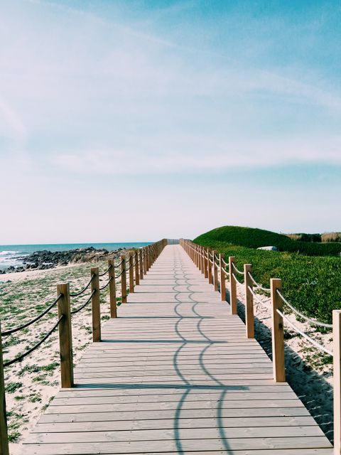 Scenic Boardwalk Extending to Beach with Clear Blue Sky - Download Free Stock Images Pikwizard.com