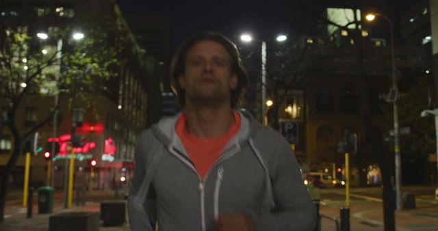 Male Jogger Running Through City at Night in Gray Sweatshirt - Download Free Stock Images Pikwizard.com