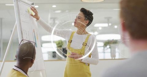 Creative team presenting with sticky notes and HUD overlay for collaborative brainstorming