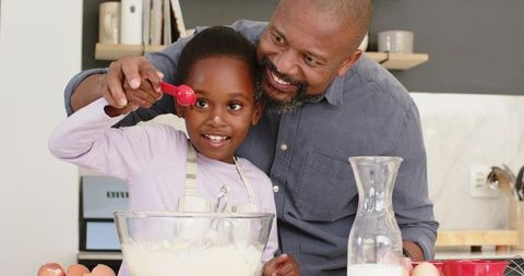 Father and Daughter Baking Together in Warm Kitchen Setting