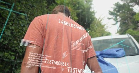 Man wearing orange t-shirt walking toward white car with augmented reality data overlay