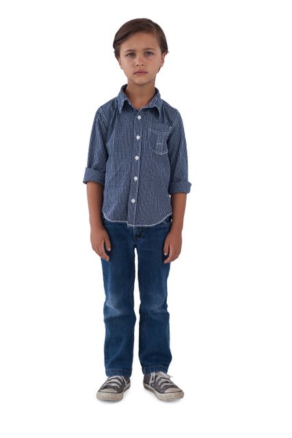 Young boy standing in casual outfit, wearing jeans and a striped shirt, against a white background. Ideal for educational materials, advertisements, family-related content, and fashion catalogs.