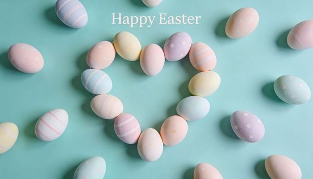 Pastel easter eggs forming heart on mint teal background with happy easter greeting