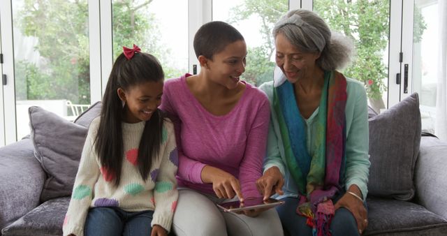 Three Generations of Women Bonding and Using Digital Tablet at Home - Download Free Stock Images Pikwizard.com